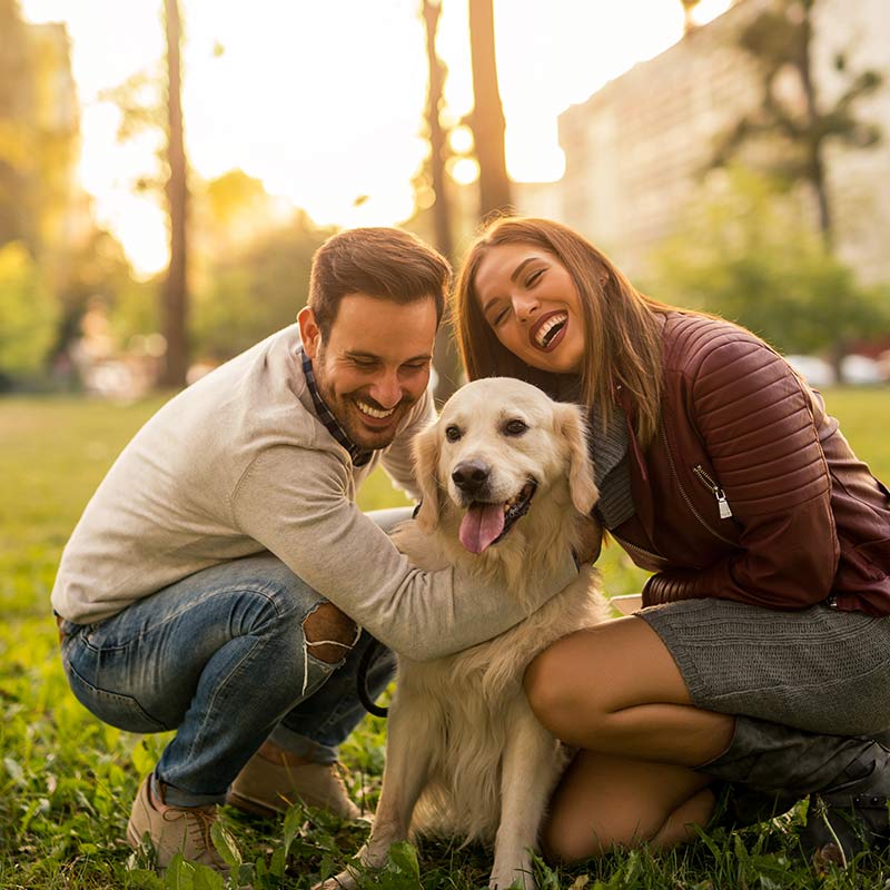 couple smiling with dog outside in Mooresville & Denver, NC